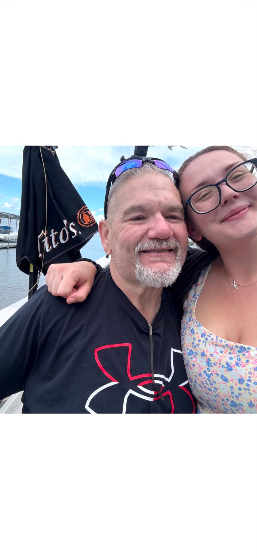 Buddy Vokey smiling on a boat with his daughter